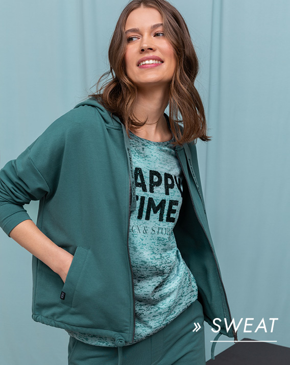 Model trägt grünes Sweatoutfit